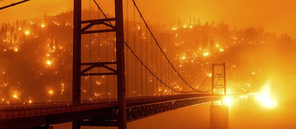 Барный мост Бидуэлл в Оровилле на фоне пылающего леса в Калифорнии - Sputnik Беларусь