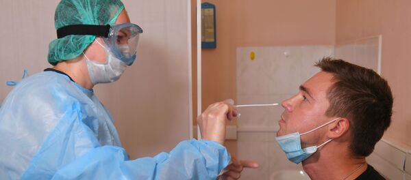 Пацыент падчас ўзяцця мазка на каронавірус COVID-19 - Sputnik Беларусь