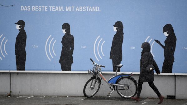 Женщина идет рядом с плакатом Лучшая команда. На расстоянии перед заводом BMW в Мюнхене - Sputnik Беларусь