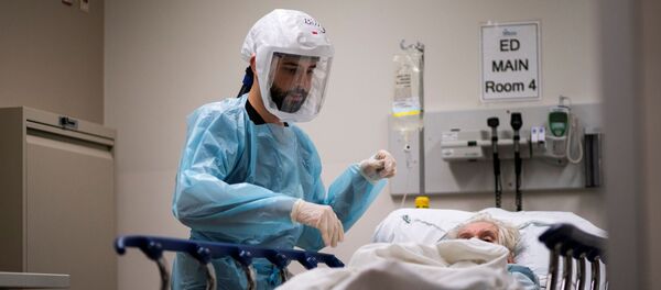 Медицинский работник проверяет пациента с положительной реакцией на коронавирус (COVID-19) в отделении COVID-19 в Региональном медицинском центре Тринитас в Элизабет, штат Нью-Джерси - Sputnik Беларусь