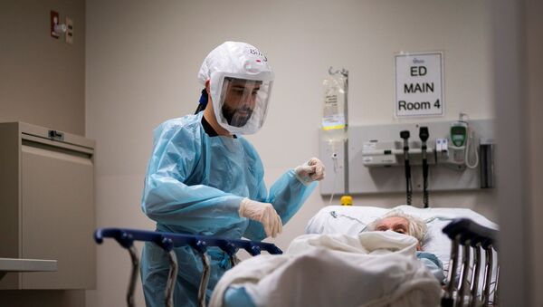 Медицинский работник проверяет пациента с положительной реакцией на коронавирус (COVID-19) в отделении COVID-19 в Региональном медицинском центре Тринитас в Элизабет, штат Нью-Джерси - Sputnik Беларусь
