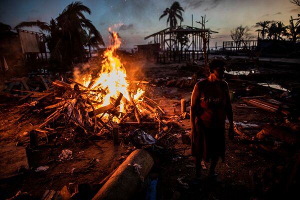Люди сжигают мусор, оставшийся после урагана Йота в Бильви, Никарагуа - Sputnik Беларусь