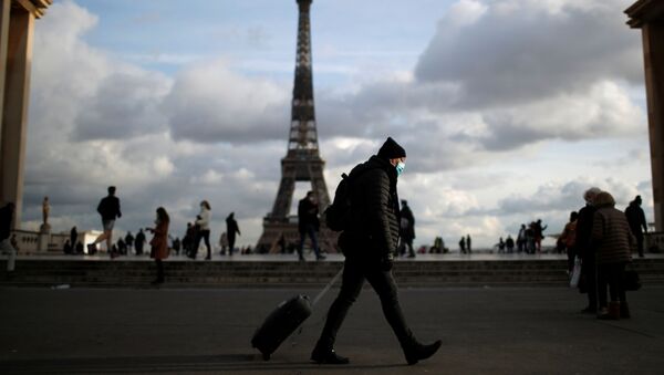 Мужчина в защитной маске гуляет по площади Трокадеро возле Эйфелевой башни в Париже - Sputnik Беларусь