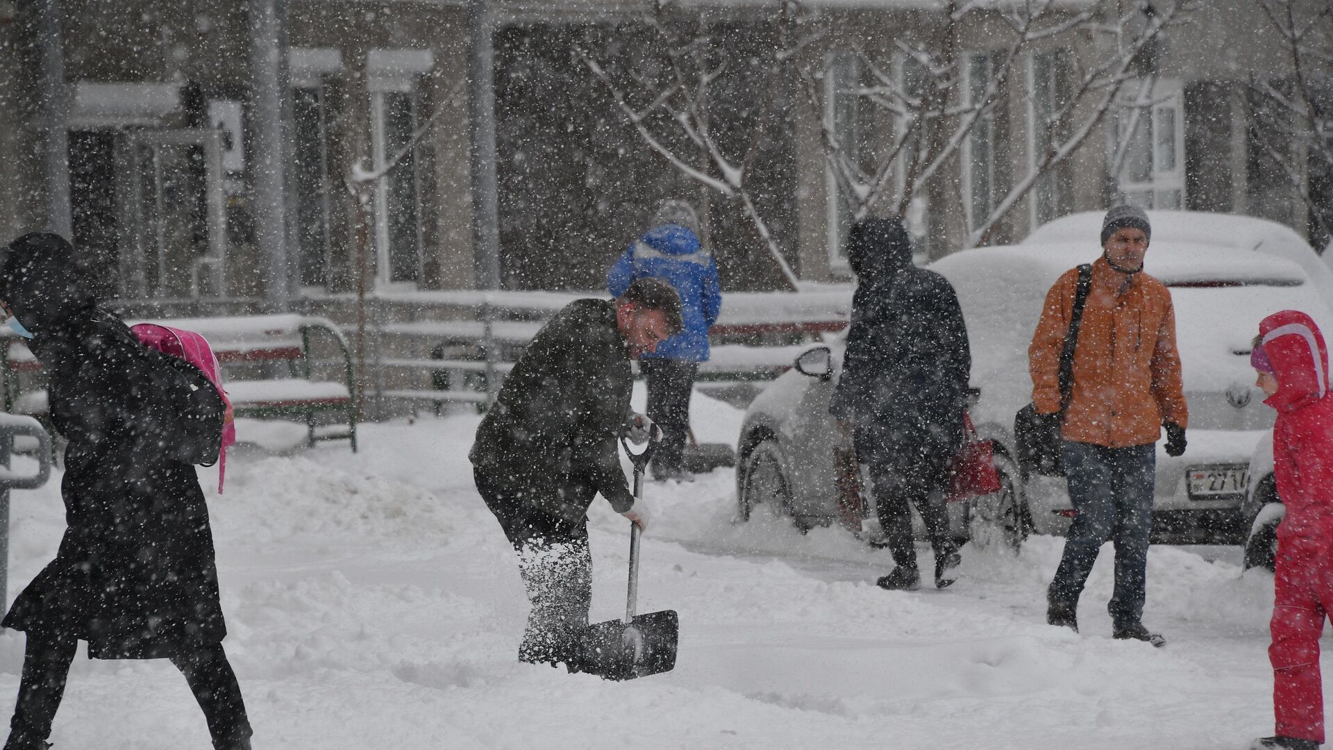 Минчанин убирает снег на территории двора - Sputnik Беларусь, 1920, 16.01.2023