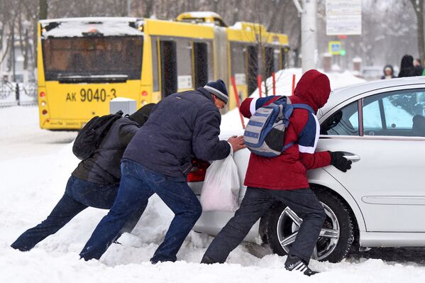 Люди выталкивают машину из снега - Sputnik Беларусь