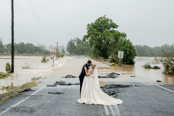 Жених и невеста целуются перед затопленным мостом Порт-Маккуори - Sputnik Беларусь
