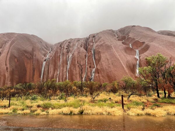 Реки воды стекают по поверхности горы Улуру в Австралии - Sputnik Беларусь