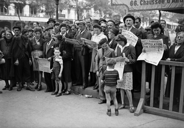 8 мая 1945 года в Париже. Люди читают газеты с сообщением о капитуляции. - Sputnik Беларусь