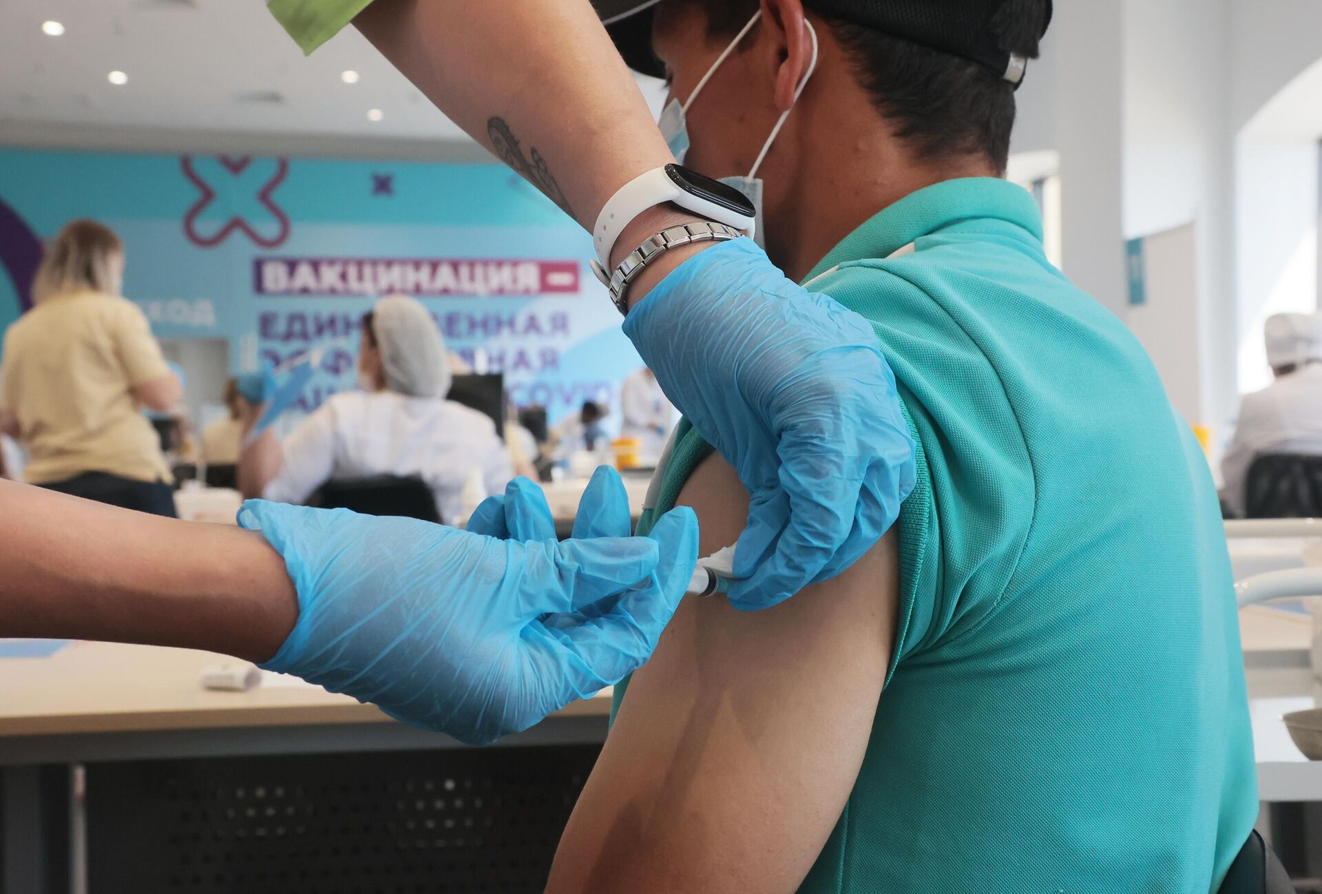 Медицинский сотрудник делает посетителю прививку от COVID-19 - Sputnik Беларусь, 1920, 08.07.2021