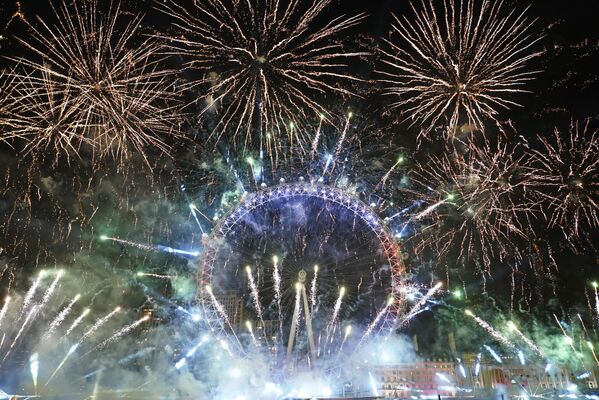 Фейерверки освещают небо над колесом обозрения Лондонский глаз в центре Лондона в воскресенье, 1 января 2023 года - Sputnik Беларусь