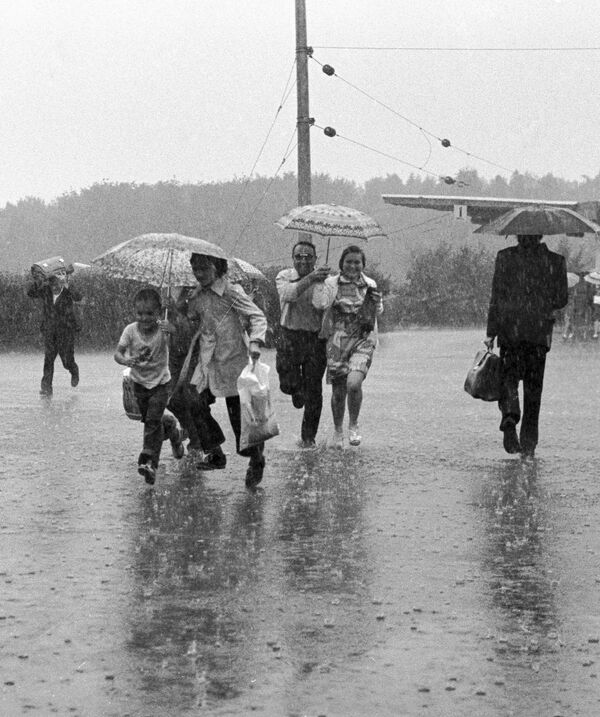 Жители города Тырныауз бегут под дождем, 1978-й. - Sputnik Беларусь
