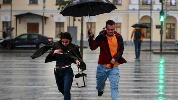 Люди бегут по пешеходному переходу во время дождя  - Sputnik Беларусь