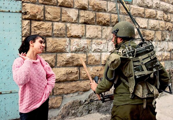 Израильская армия вошла на палестинскую территорию в ходе первой интифады, длившейся с 1987 по 1991 год. В итоге столкновения завершились подписанием Соглашения &quot;Осло&quot; о мирном урегулировании между Израилем и Палестинской автономией.На фото: палестинская девушка провоцирует израильского солдата 28 февраля 1988 года в Бет-Сахуре. - Sputnik Беларусь