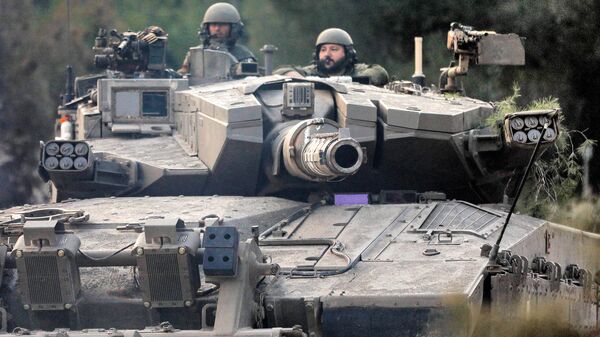 Солдаты израильской армии в башне боевого танка, движущегося по позиции в верхней части Галилеи на севере Израиля недалеко от границы с Ливаном - Sputnik Беларусь