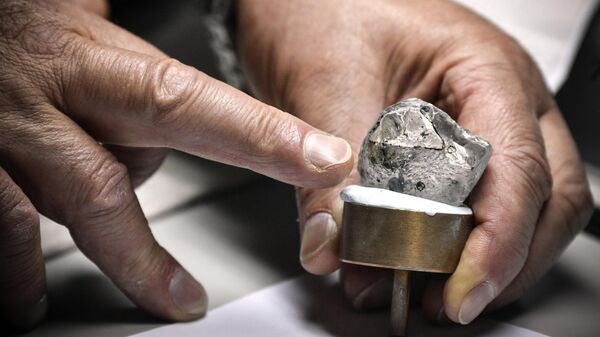 Сотрудник гранильного подразделения АЛРОСА в Москве осматривает необработанные алмазы, архивное фото - Sputnik Беларусь
