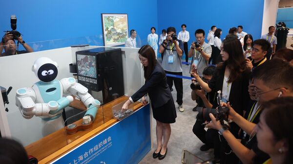 Робот готовит мороженое в Медиацентре саммита Шанхайской организации сотрудничества (ШОС) 2025 года, Тяньцзинь, Китай - Sputnik Беларусь