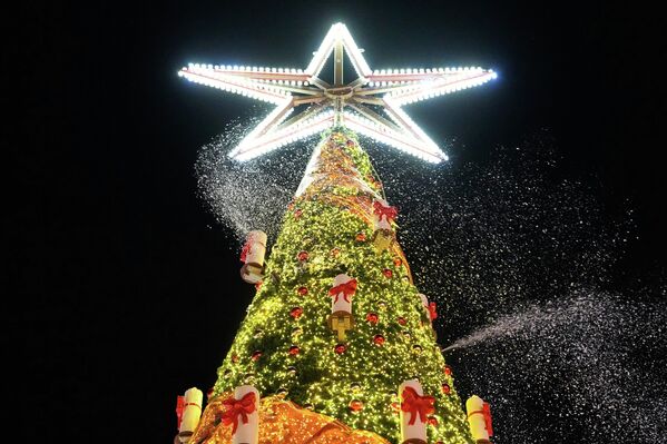 Рождественская елка, припорошенная снегом, на ярмарке аттракционов в Херне, Германия. - Sputnik Беларусь