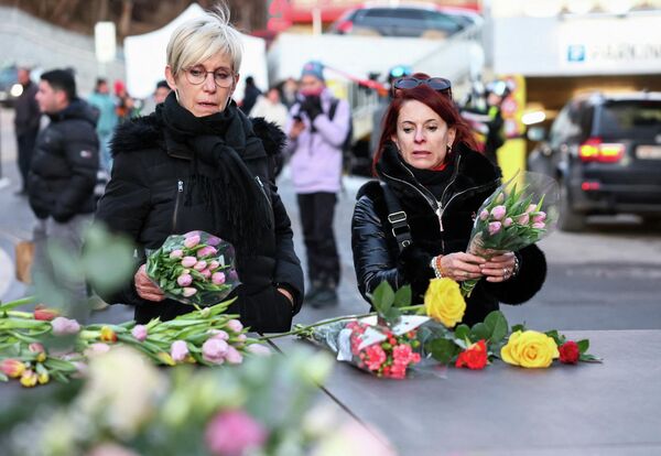 Люди оставляют цветы у бара &amp;quot;Le Constellation&amp;quot; после пожара и взрыва во время новогодней вечеринки.