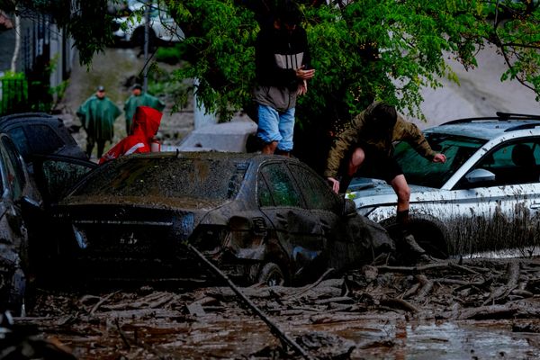 Мужчины перебираются через завязшие в грязи автомобили в районе Лас-Кондес в Сантьяго. - Sputnik Беларусь
