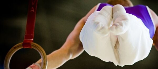 Гимнаст на кольцах. Архивное фото - Sputnik Беларусь