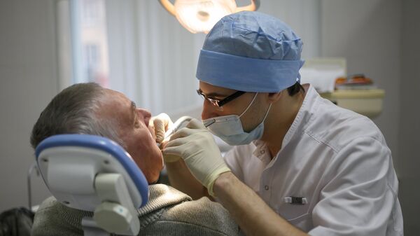 Пациент на приеме у стоматолога, архивное фото - Sputnik Беларусь