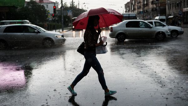 Девушка идет по улице во время дождя - Sputnik Беларусь