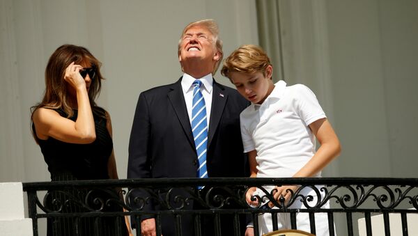 Президент США Дональд Трамп наблюдает солнечное затмение с первой леди Меланией и сыном Барроном с балкона Трумэна в Белом доме в Вашингтоне - Sputnik Беларусь