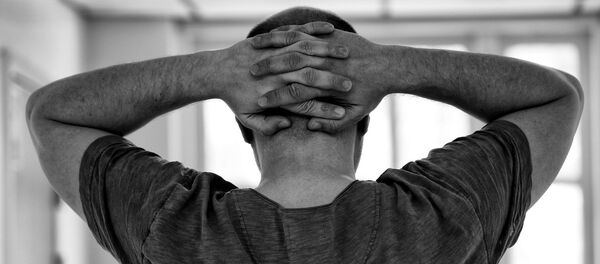 Мужчина держит руки за головой, архивное фото - Sputnik Беларусь