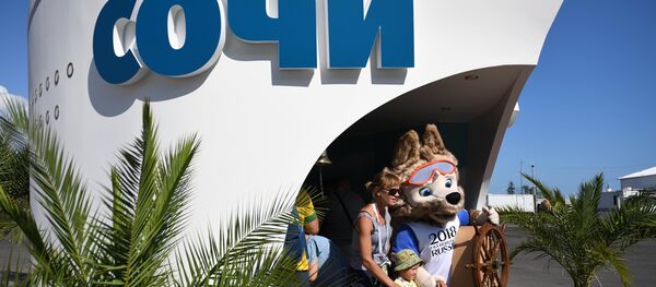 Болельщик фотографируется с официальным талисманом чемпионата мира по футболу 2018 - Sputnik Беларусь