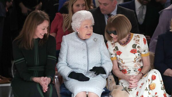 Королева Елизавета II на показе Недели моды в Лондоне, справа от нее - глава Британского модного совета Каролин Раш, слева - шеф-редактор Vogue Анна Винтур - Sputnik Беларусь
