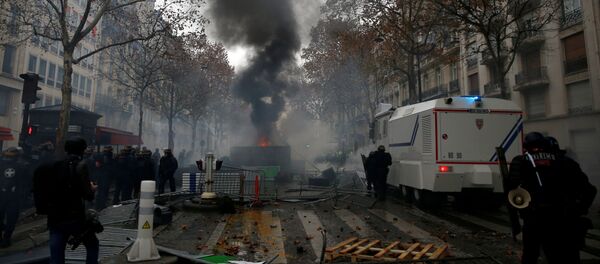ОМОН возле баррикады во время столкновений с протестующими в желтых жилетах в Париже - Sputnik Беларусь