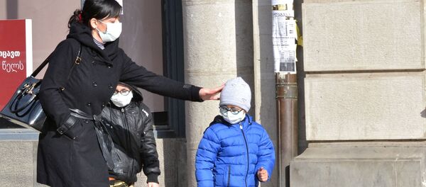 Женщина с детьми в медицинских масках в целях профилактики заболевания гриппом - Sputnik Беларусь