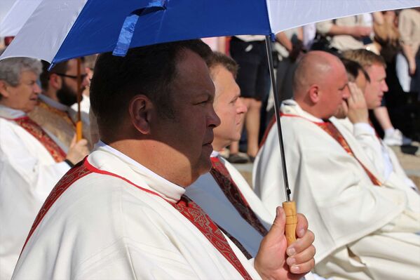 Сегодня в Минске было очень жарко, священнослужители укрывались зонтами от палящего солнца. - Sputnik Беларусь