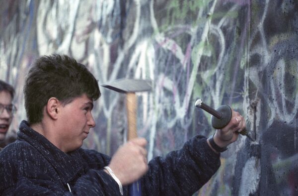В последующие месяцы люди приступили к разбору Берлинской стены, многие брали себе кусочек на память. Часть стены, расписанная с западной стороны различными граффити, стала объектом искусства. - Sputnik Беларусь