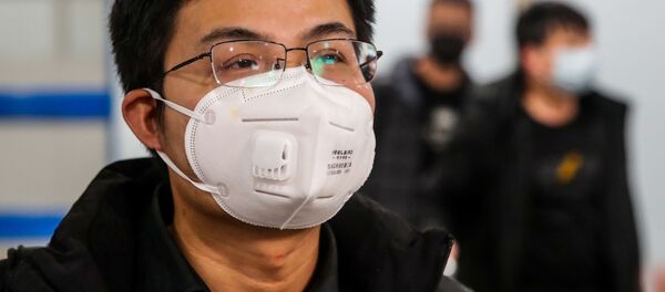Житель Китая в маске, архивное фото - Sputnik Беларусь