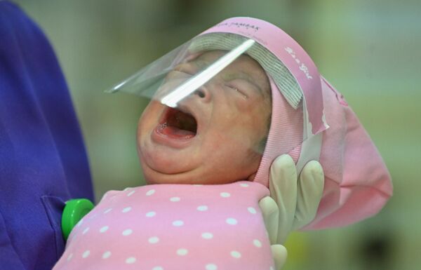 Медсестра держит новорожденного ребенка в родильном доме в Джакарте, Индонезия - Sputnik Беларусь