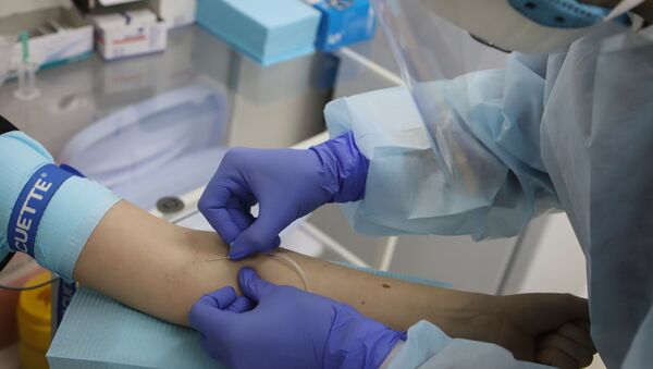 Медицинский работник выполняет забор крови для тестирования на наличие антител к вирусу SARS-CoV-2 - Sputnik Беларусь