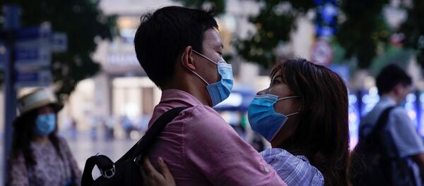Пара в медицинских масках на улице в Шанхае - Sputnik Беларусь
